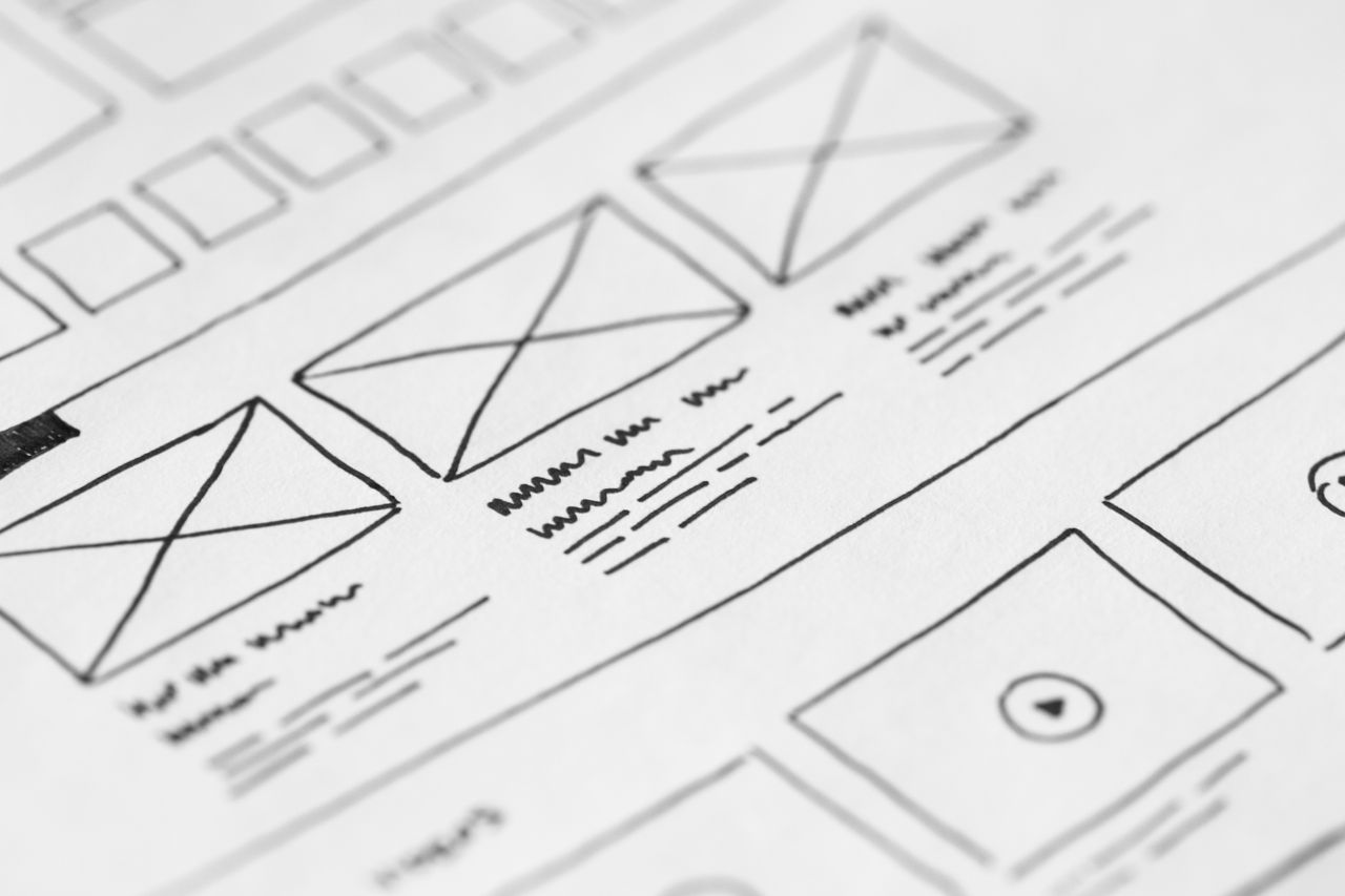 our-mission Detailed close-up of a hand-drawn wireframe design on paper for a UX project.